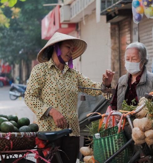 Commodities - Women Standing with a Bike with Vegetables