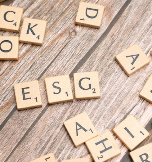 ESG Investing - Wooden letter tiles spell ESG on a rustic wooden surface, emphasizing sustainability.