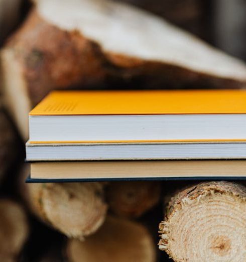 Resources - Books placed on edge of freshly prepared woodpile in backyard of countryside house