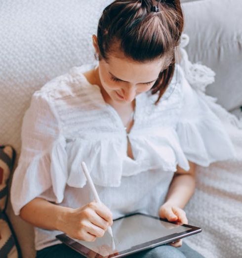 Flexible Work - Woman Working on a Tablet in her Living Room