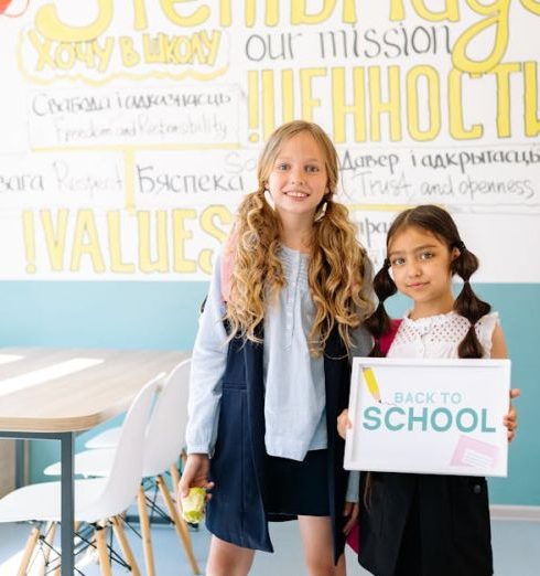 Mission Statement - Two young girls stand in a vibrant classroom, ready for back-to-school season.