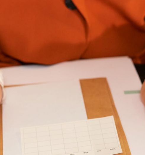 Action Plan - Businesswoman holding a clipboard with notes, planning and organizing tasks.