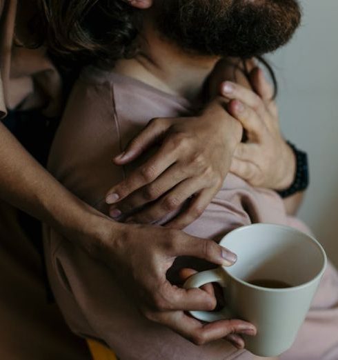 Communication - A couple in a warm embrace enjoying coffee, embodying a relaxed and loving atmosphere.