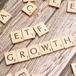 Market Expansion - Wooden tiles spelling ETF growth on a wooden surface, symbolizing investment strategy.