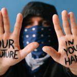 Actionable Strategy - Close-up of hands displaying a powerful protest message "Our future in your hands."