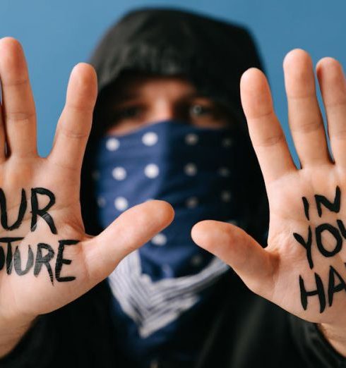 Actionable Strategy - Close-up of hands displaying a powerful protest message "Our future in your hands."