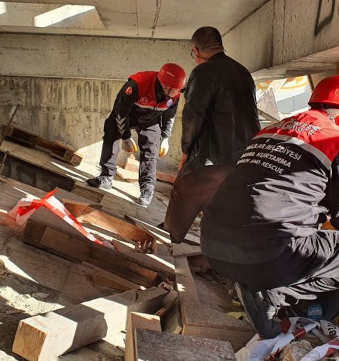 Needs Assessment - Rescue workers in Istanbul inspecting a damaged structure for safety and recovery efforts.