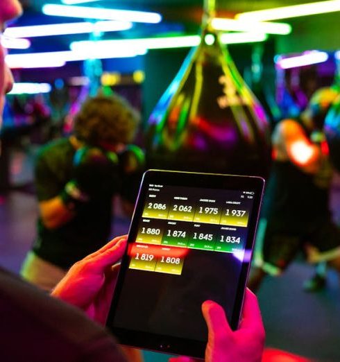 Tracking - Fitness training in a modern gym with technology for tracking performance on a tablet.