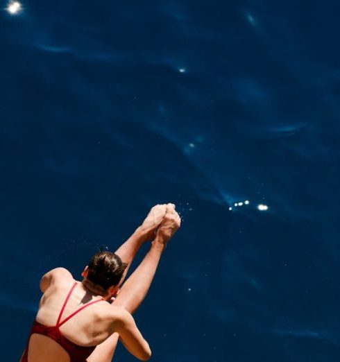 Reputational Risk - Female Diver Mid-Air Over Deep Blue Sea