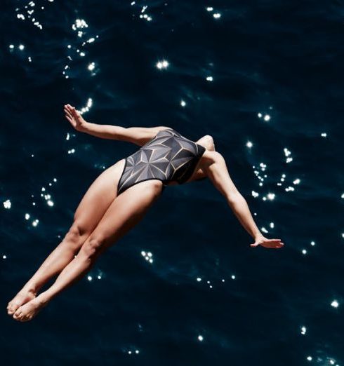 Risk Committee - Fearless Woman Diving into Ocean Waters