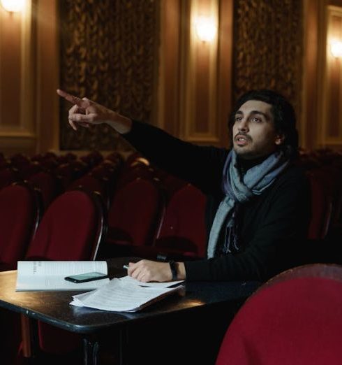 Scenario Planning - A theater director gestures in an empty auditorium during a rehearsal planning session.