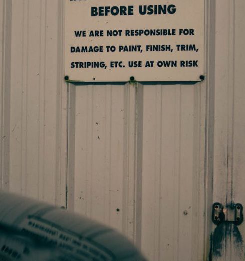 Risk Workshop - An indoor car garage scene with caution and warning signs on the wall.