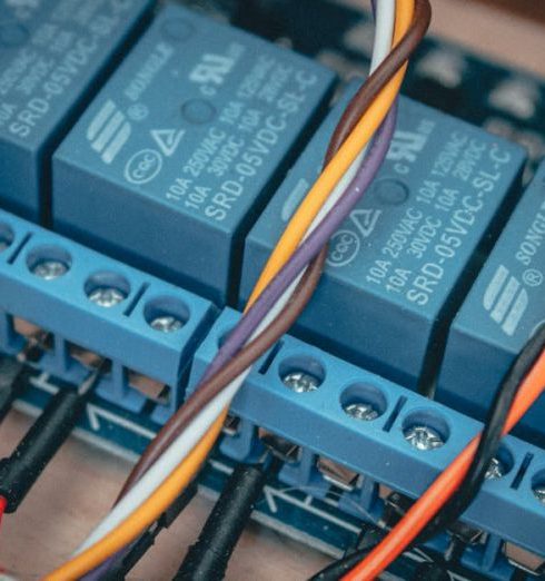 Internal Controls - Blue relay modules with colorful wires connected on an electronic board.