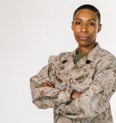 Core Values - Portrait of a female African American soldier in a US Marines uniform on a white background.