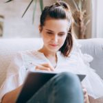 Work-Life Balance - Woman Sitting on a Sofa and Using a Tablet