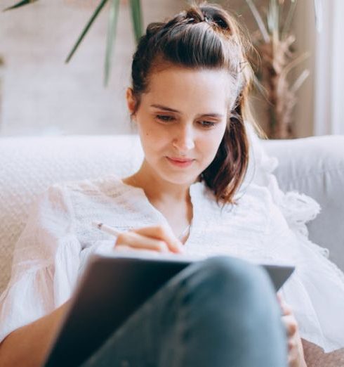 Work-Life Balance - Woman Sitting on a Sofa and Using a Tablet