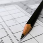 Measurement - Detailed image of a black pencil resting on architectural blueprints, ideal for design and planning themes.