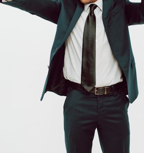 Peer Recognition - Confident businessman in a suit celebrates an award victory in a studio setting.