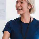 Integrity - Friendly businesswoman in a blue shirt shaking hands during meeting, radiating professionalism and approachability.