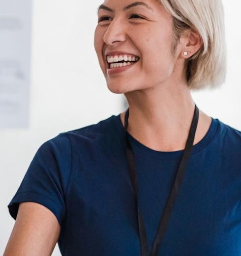 Integrity - Friendly businesswoman in a blue shirt shaking hands during meeting, radiating professionalism and approachability.