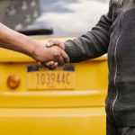 Respect - Side view of crop ethnic anonymous males shaking hands while meeting each other on street