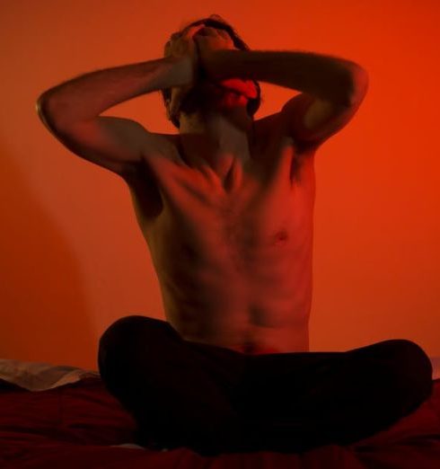 Mental Health - Topless Man Sitting on the Bed