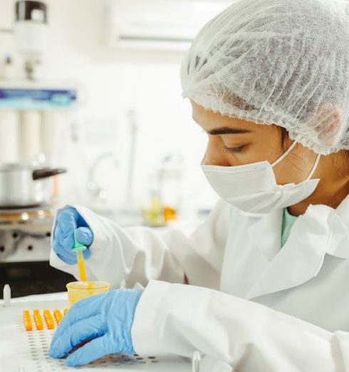 Data Collection - A scientist wearing protective gear performs a meticulous experiment in a laboratory setting.