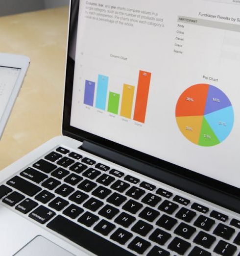 Data Analysis - Laptop displaying charts and graphs with tablet calendar for data analysis and planning.