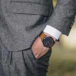 Trends - Close-up of a man in a tailored suit wearing an elegant wristwatch outdoors, exuding fashion and sophistication.