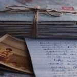 Sentiment Analysis - Close-up of vintage letters tied together with a twine, accompanied by an old photograph and handwritten note.