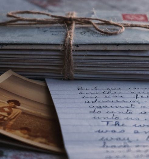 Sentiment Analysis - Close-up of vintage letters tied together with a twine, accompanied by an old photograph and handwritten note.