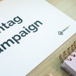 Marketing Campaigns - A clean office desk setup featuring hashtag campaign marketing materials and a planner.