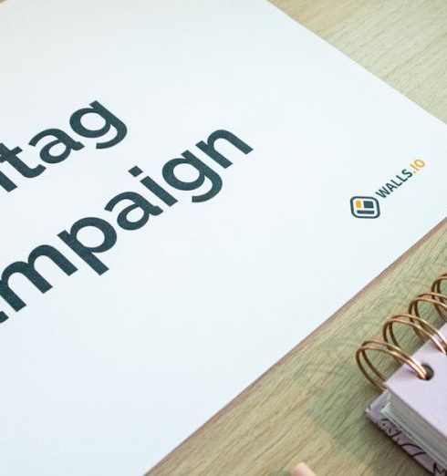 Marketing Campaigns - A clean office desk setup featuring hashtag campaign marketing materials and a planner.