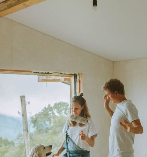 Pet-Friendly Renovation - A Happy Couple Dancing With Their Dog