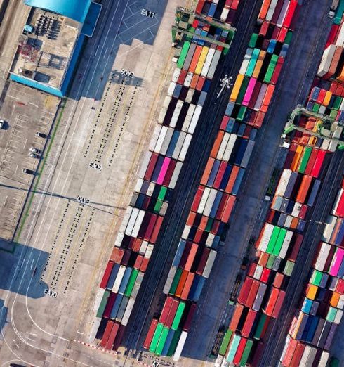 Supply Chain - Top view of colorful shipping containers at a bustling port in Jakarta, Indonesia.