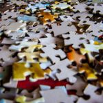 Challenges - A colorful collection of jigsaw puzzle pieces scattered on a flat surface, ideal for hobby and leisure themes.