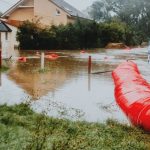 Risk Mitigation - Flooded Residential Area with Red Barrier