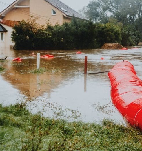 Risk Mitigation - Flooded Residential Area with Red Barrier