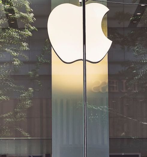 Brand Presence - A casual scene of a man walking past the iconic glass facade of an Apple Store in Beijing, China.