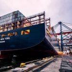 Logistics - A large cargo ship docked at Gothenburg port with industrial cranes, Sweden.