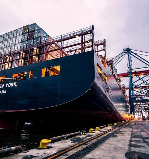 Logistics - A large cargo ship docked at Gothenburg port with industrial cranes, Sweden.