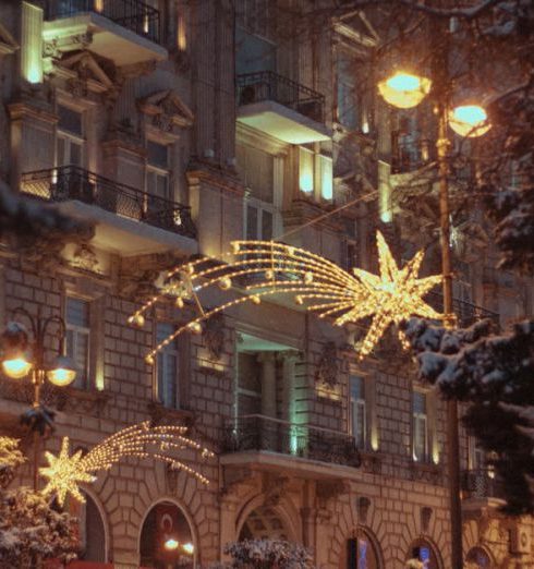 Outdoor Lighting - Charming winter evening street view in Baku decorated with festive lights and snow.