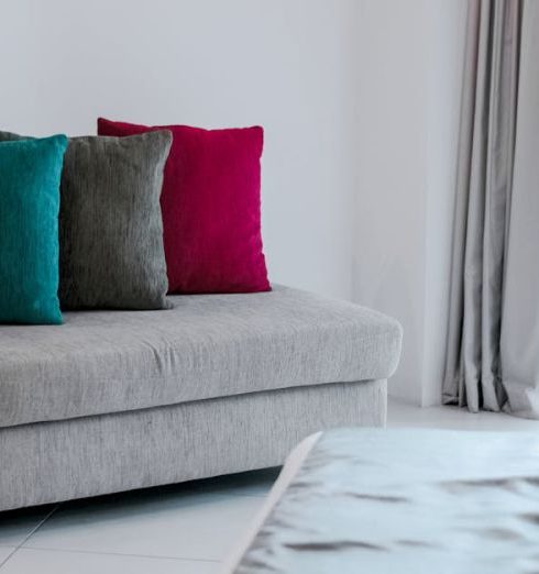 Colorful Cushions - Red Throw Pillow on Gray Fabric Chaise Lounge Near Gray Window Curtain