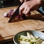 Chef’s Knife - Person Slicing Vegetable on Chopping Board