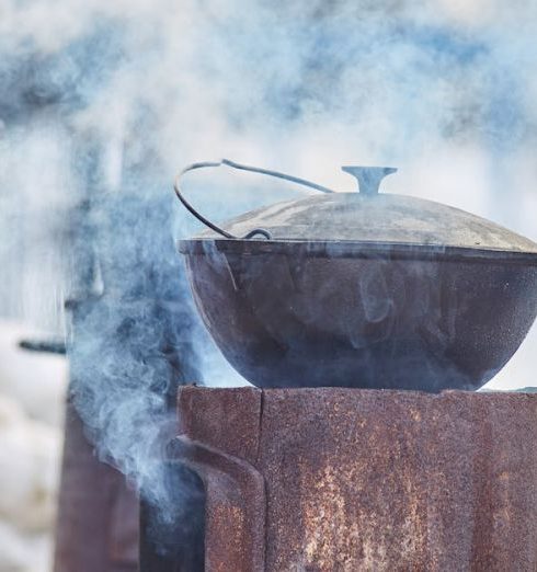 Cast Iron Cookware - A Cast Iron Pot on a Metal Stove