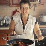 Pots And Pans - Woman Wearing Apron While Smiling