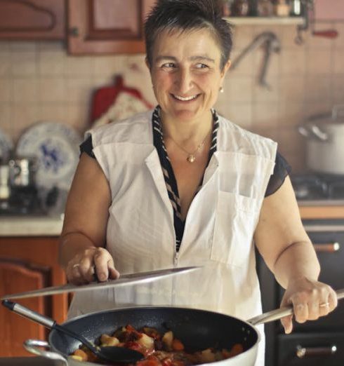 Pots And Pans - Woman Wearing Apron While Smiling