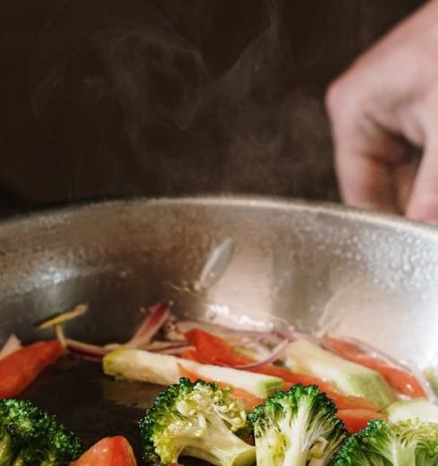 Nonstick Cookware - Person Holding Black Cooking Pan With Vegetable Salad