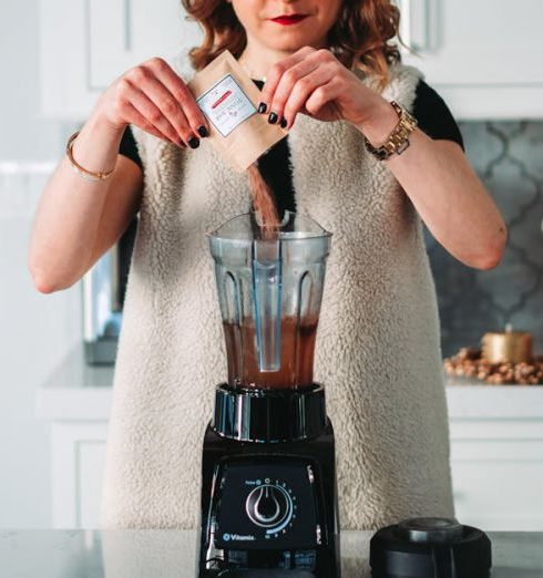 Blender - Womna Pouring Powder on the Blender