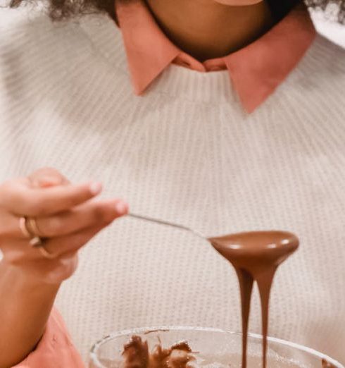 Silicone Bakeware - Focused black woman pouring batter into molds